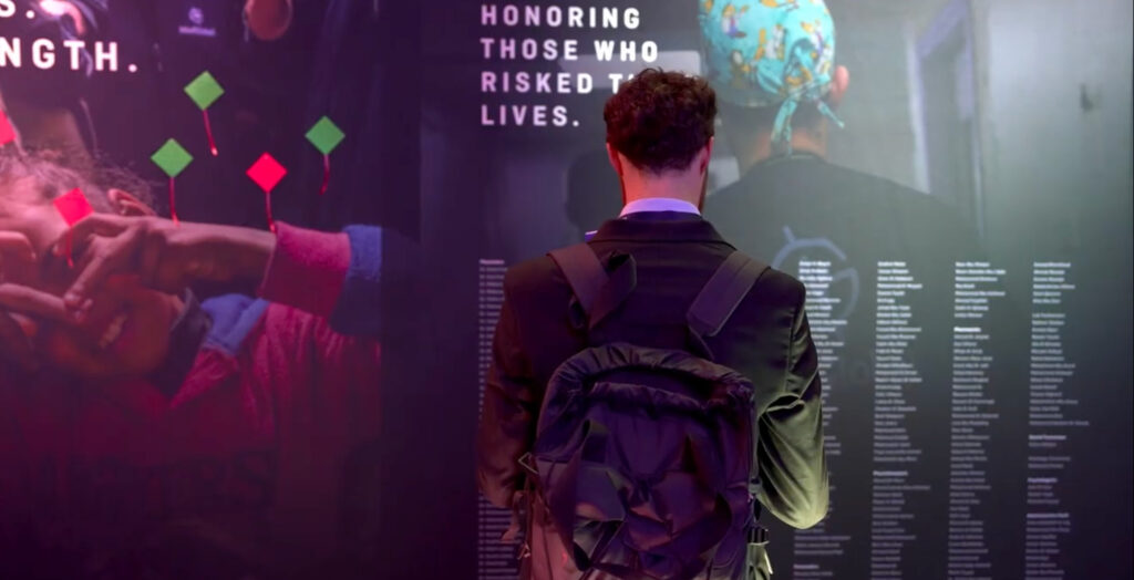 A man is shown looking at a memorial of doctors who died in Gaza