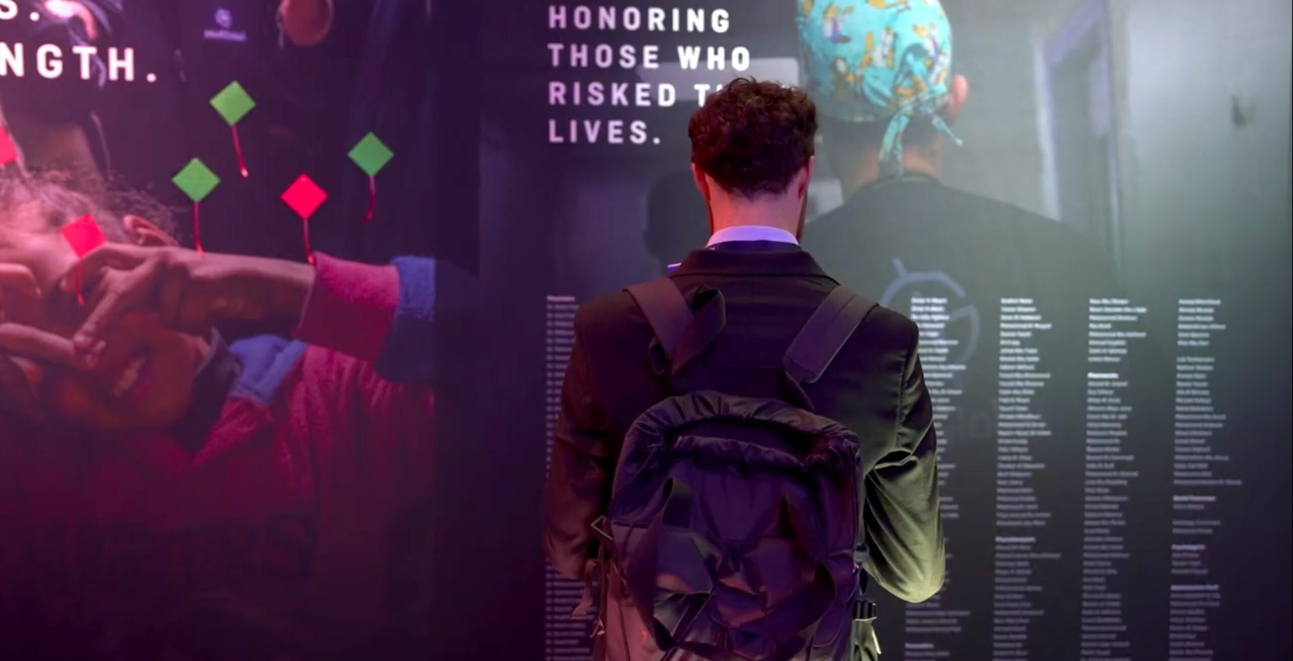 A man is shown looking at a memorial of doctors who died in Gaza